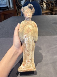 Two Chinese polychrome pottery figures and a female head, Tang