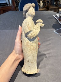 Two Chinese polychrome pottery figures and a female head, Tang