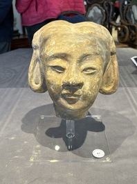 Two Chinese polychrome pottery figures and a female head, Tang