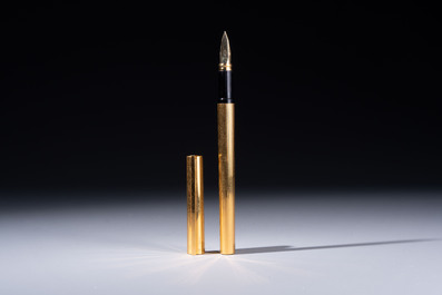 A gold-plated twist ballpoint pen and a fountain pen with an 18kt gold nib, S.T. Dupont Paris, France, 20th C.