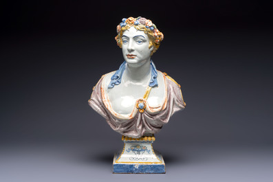 A large polychrome French faience monogrammed bust of a woman emblematic of spring, probably Rouen, early 19th C.