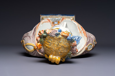 A large polychrome French faience monogrammed bust of a woman emblematic of spring, probably Rouen, early 19th C.