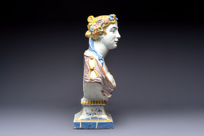 A large polychrome French faience monogrammed bust of a woman emblematic of spring, probably Rouen, early 19th C.
