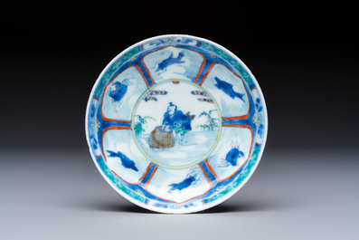 A Chinese European-decorated blue and white 'Fisherman' cup and saucer, Kangxi