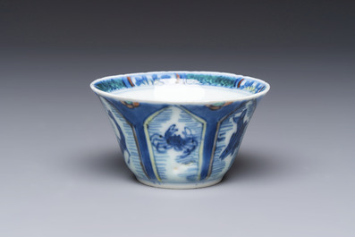 A Chinese European-decorated blue and white 'Fisherman' cup and saucer, Kangxi
