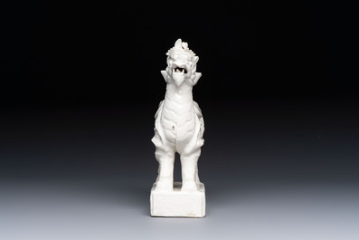 A Chinese Dehua blanc de Chine candlestick in the form a qilin, Kangxi