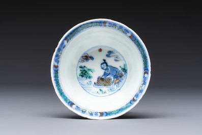 A Chinese European-decorated blue and white 'Fisherman' cup and saucer, Kangxi