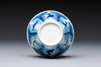 A Chinese European-decorated blue and white 'Fisherman' cup and saucer, Kangxi