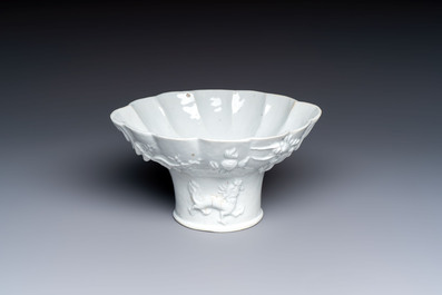A very large Chinese Dehua blanc de Chine libation cup with a dragon, a qilin, a tiger and a crane, 18th C.