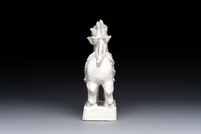 A Chinese Dehua blanc de Chine candlestick in the form a qilin, Kangxi