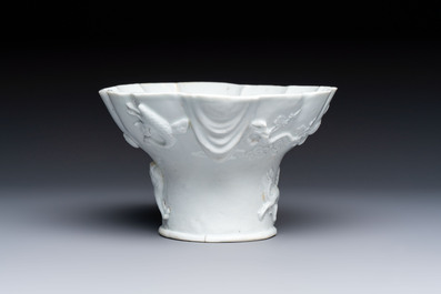 A very large Chinese Dehua blanc de Chine libation cup with a dragon, a qilin, a tiger and a crane, 18th C.