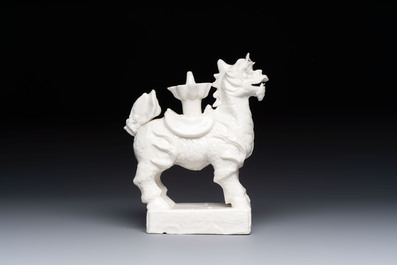 A Chinese Dehua blanc de Chine candlestick in the form a qilin, Kangxi