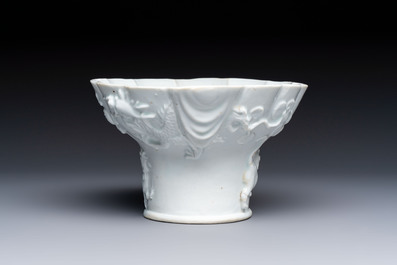 A very large Chinese Dehua blanc de Chine libation cup with a dragon, a qilin, a tiger and a crane, 18th C.
