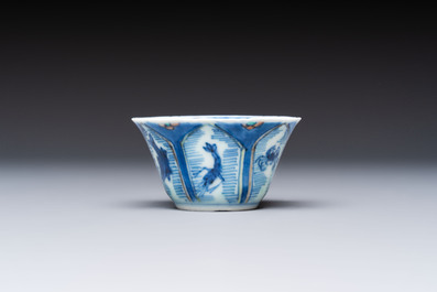 A Chinese European-decorated blue and white 'Fisherman' cup and saucer, Kangxi