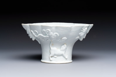 A very large Chinese Dehua blanc de Chine libation cup with a dragon, a qilin, a tiger and a crane, 18th C.