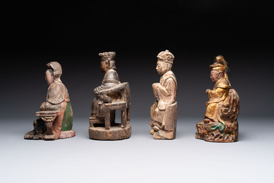 Eight Chinese carved wooden sculptures with traces of polychromy and gilding, 19th C.