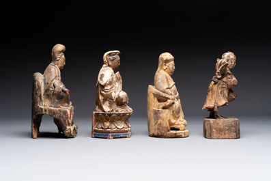 Eight Chinese carved wooden sculptures with traces of polychromy and gilding, 19th C.