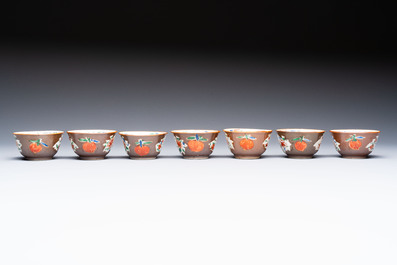 A Chinese famille rose capucine-ground covered teapot with floral design, seven cups and saucers, Yongzheng/Qianlong