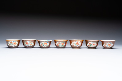 A Chinese famille rose capucine-ground covered teapot with floral design, seven cups and saucers, Yongzheng/Qianlong