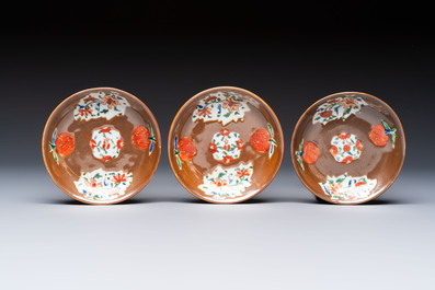A Chinese famille rose capucine-ground covered teapot with floral design, seven cups and saucers, Yongzheng/Qianlong