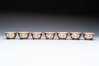 A Chinese famille rose capucine-ground covered teapot with floral design, seven cups and saucers, Yongzheng/Qianlong