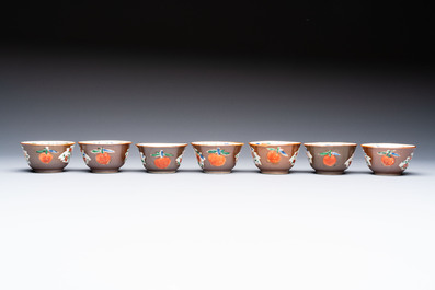 A Chinese famille rose capucine-ground covered teapot with floral design, seven cups and saucers, Yongzheng/Qianlong