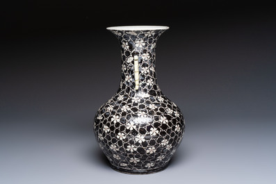 A rare Chinese famille noire 'Prunus on Cracked Ice' vase with 'Chilong' handles, 19th C.