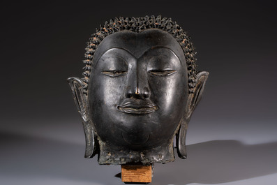 A Cambodian bronze Buddha and a Thai Buddha head, 19th C.