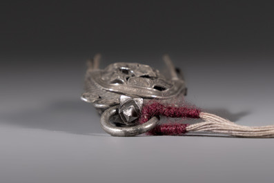 A fine Chinese silver pendant with inscriptions on a plexiglas stand, 19th C.