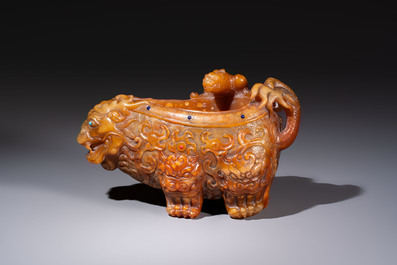 A Chinese precious-stone-inlaid carved soapstone wine vessel on stand, Gong 觥, Republic