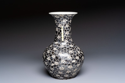 A rare Chinese famille noire 'Prunus on Cracked Ice' vase with 'Chilong' handles, 19th C.