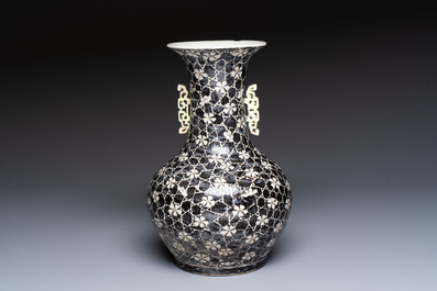 A rare Chinese famille noire 'Prunus on Cracked Ice' vase with 'Chilong' handles, 19th C.