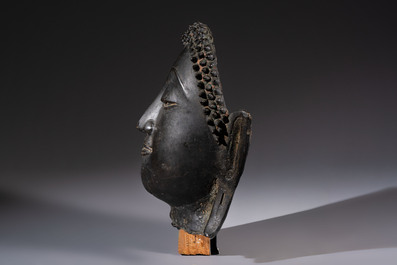 A Cambodian bronze Buddha and a Thai Buddha head, 19th C.