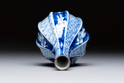 A Japanese blue and white sake bottle with figural design, Meiji, 19th C.