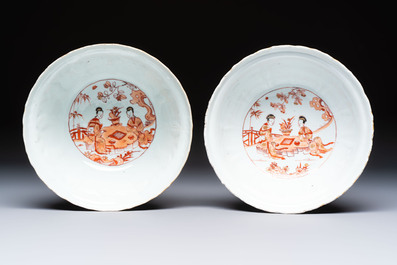 A pair of Chinese  iron-red and gilt-decorated 'Elegant Ladies and Tulips' bowls and covers, Kangxi