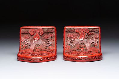 A pair of Chinese cinnabar lacquer bookends, a covered box and a brush washer, 19/20th C.