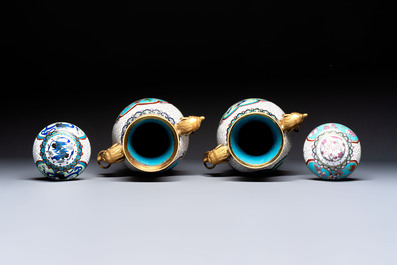 Two Chinese cloisonn&eacute; vases on wooden stands, 20th C.