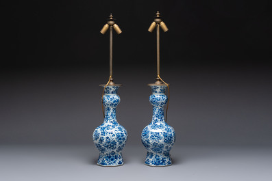 A pair of blue and white Dutch Delft garlic-head vases mounted as lamps, 18th C.