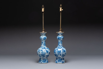 A pair of blue and white Dutch Delft garlic-head vases mounted as lamps, 18th C.