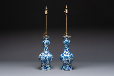 A pair of blue and white Dutch Delft garlic-head vases mounted as lamps, 18th C.