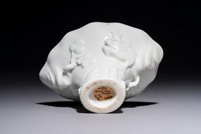 A Chinese Dehua blanc de Chine 'Dragon, Carp, Crane and Deer' libation cup, Kangxi