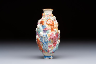 A Chinese famille rose moulded '18 Luohan' snuff bottle, Qianlong mark, 19th C.