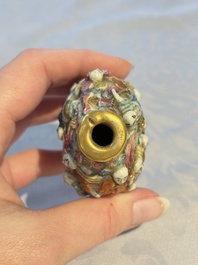 A Chinese famille rose moulded '18 Luohan' snuff bottle, Qianlong mark, 19th C.
