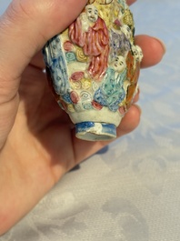 A Chinese famille rose moulded '18 Luohan' snuff bottle, Qianlong mark, 19th C.