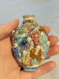 A Chinese famille rose moulded '18 Luohan' snuff bottle, Qianlong mark, 19th C.