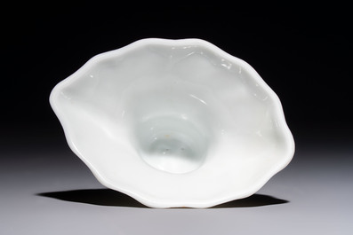 A Chinese Dehua blanc de Chine 'Dragon, Carp, Crane and Deer' libation cup, Kangxi