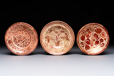 Three Hispano-Moresque lustre-ware plates on later metal stands, Spain, 17/18th C.