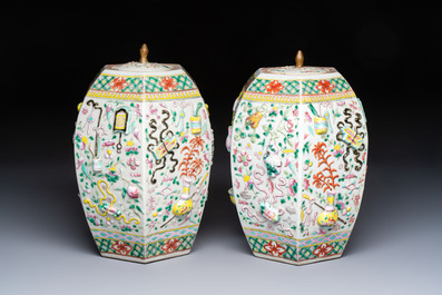 A pair of Chinese famille rose 'Antiquities' vases and covers, 19th C.