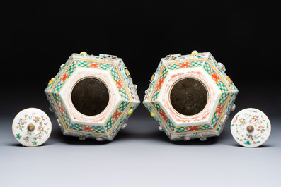 A pair of Chinese famille rose 'Antiquities' vases and covers, 19th C.