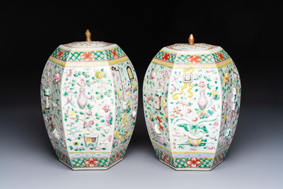A pair of Chinese famille rose 'Antiquities' vases and covers, 19th C.